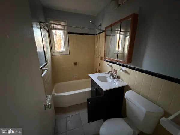a bathroom with a sink a toilet and tub