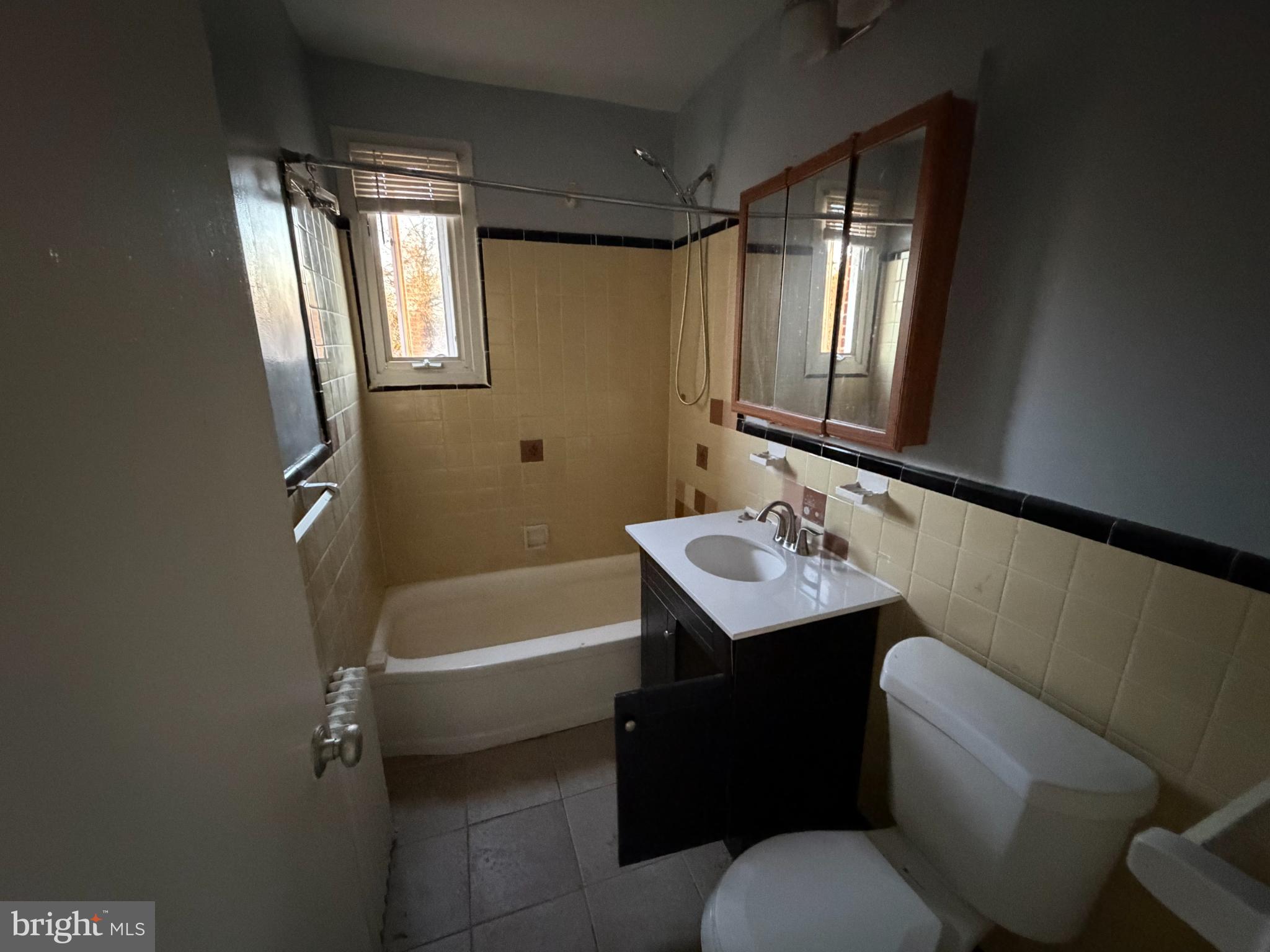 428 Ridge Road Southeast, Unit 205 Washington, DC 20019 - Photo 6 of 8 a bathroom with a sink a toilet and tub