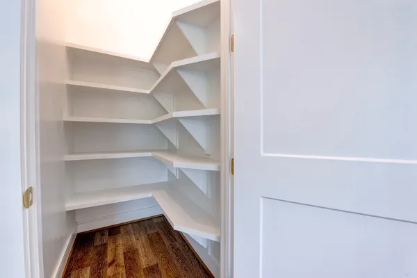 a view of walk in closet with empty racks
