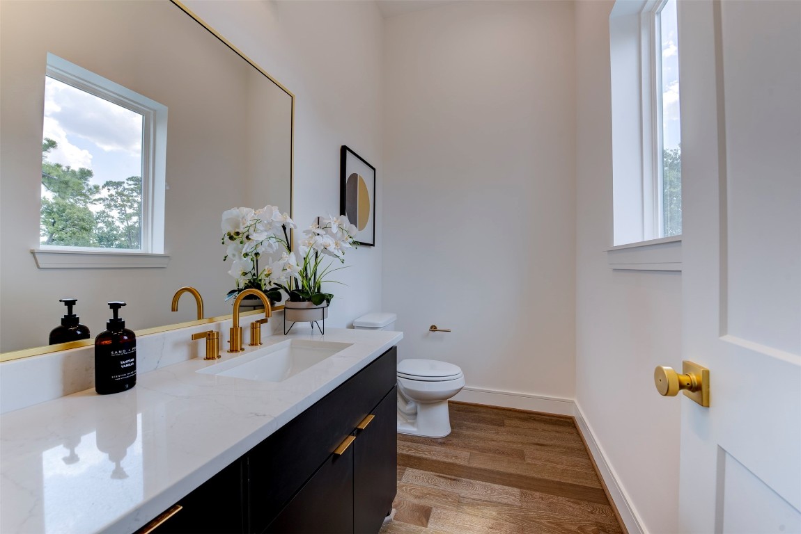 7120 Gary Street, Unit B Houston, TX 77055 - Photo 18 of 29 a bathroom with a sink a mirror and a toilet
