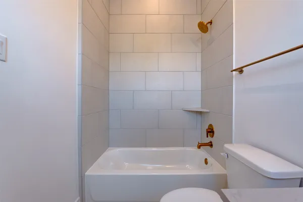 a bathroom with a bathtub and toilet