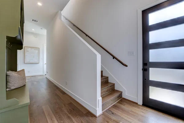 a view of entryway and hall with wooden floor