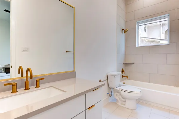 a bathroom with a toilet a sink and bathtub