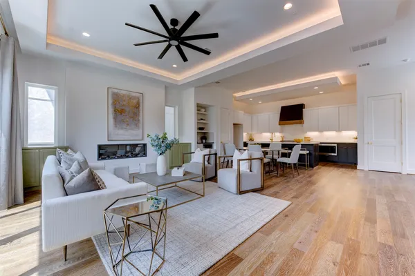 a living room with furniture and a wooden floor