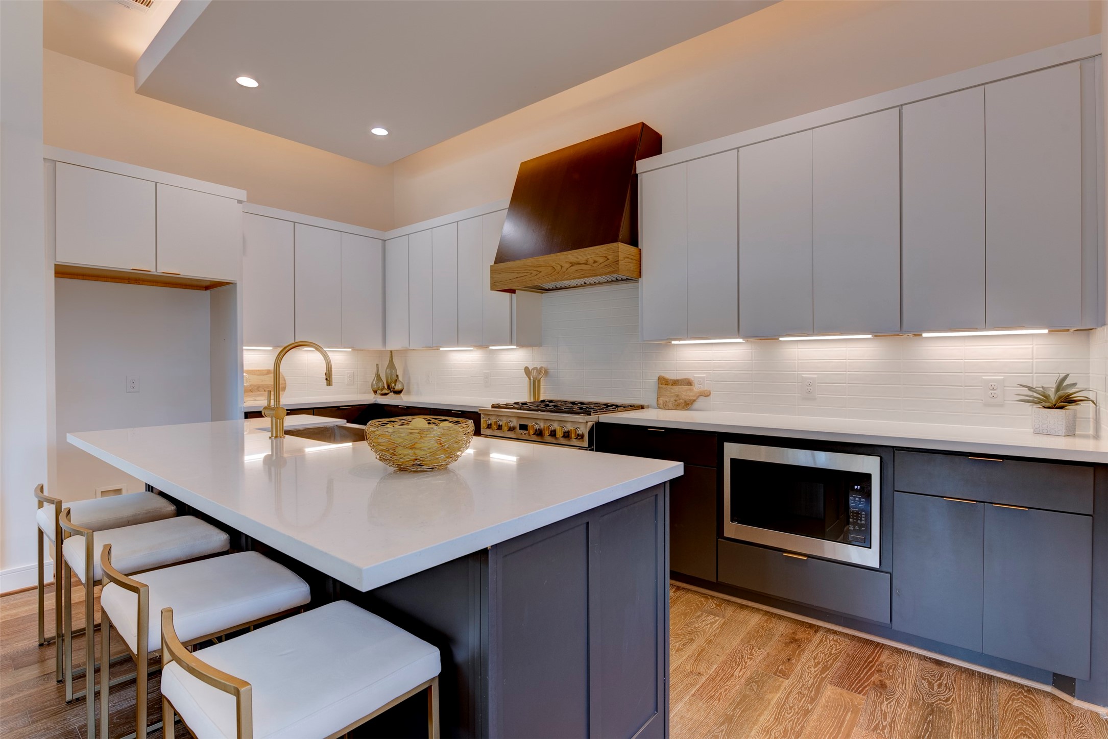 7120 Gary Street, Unit B Houston, TX 77055 - Photo 10 of 29 View of clean cabinetry and storage. Built-in microwave and high-end gas range. The kitchen features modern appliances and ample storage solutions, perfect for culinary enthusiasts and those who value organization.