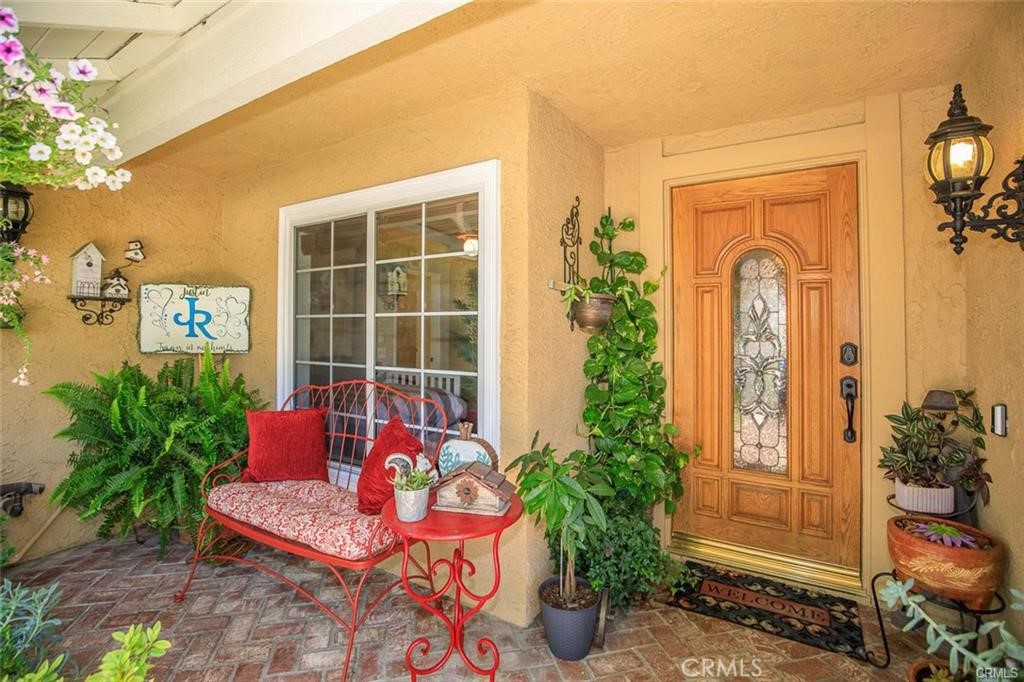 20818 Benz Road Saugus, CA 91350 - Photo 2 of 2 a vase with flowers sitting on a table in front of a house