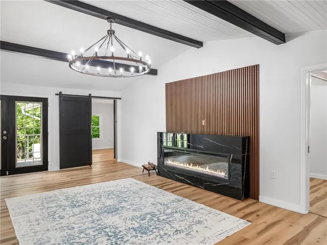 a large bedroom with a bed and wooden floor