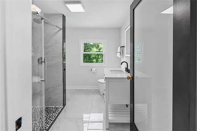 a bathroom with a shower and a sink