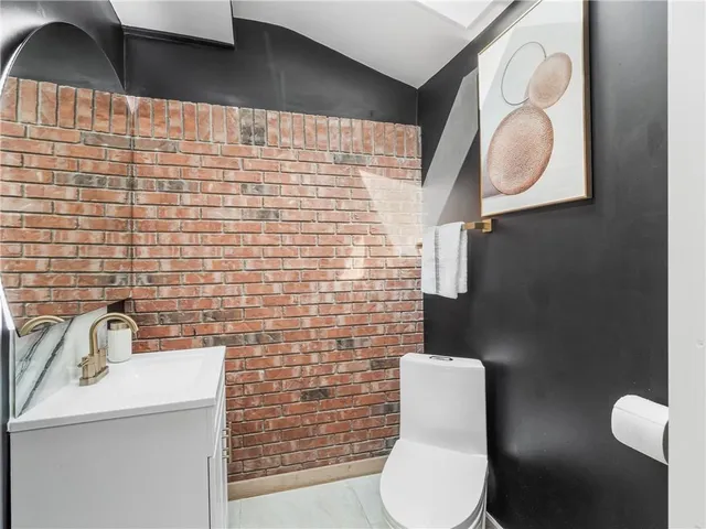 a bathroom with a toilet a sink and mirror