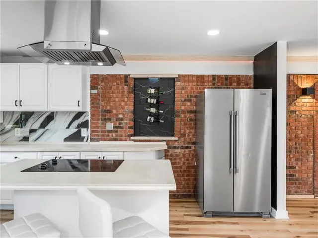 a kitchen with stainless steel appliances a refrigerator and a sink