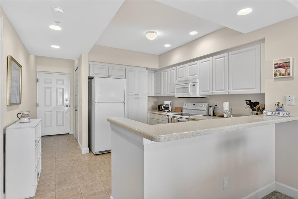 3191 Matecumbe Key Road, Unit 304 Punta Gorda, FL 33955 - Photo 14 of 31 a kitchen with stainless steel appliances granite countertop a refrigerator sink and white cabinets