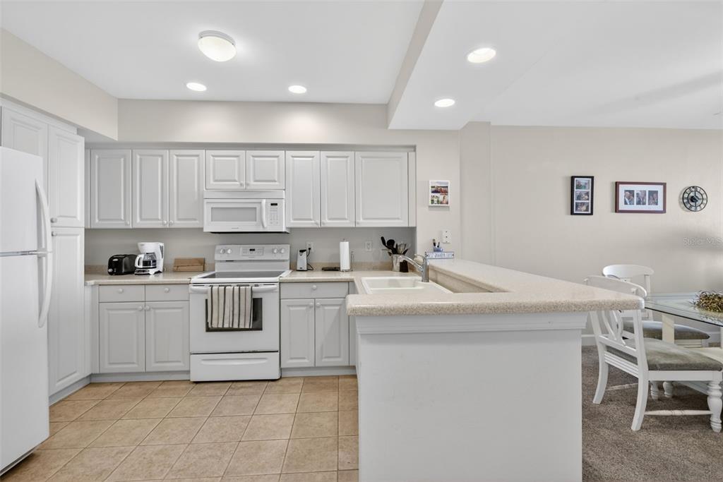 3191 Matecumbe Key Road, Unit 304 Punta Gorda, FL 33955 - Photo 18 of 31 a kitchen with white cabinets