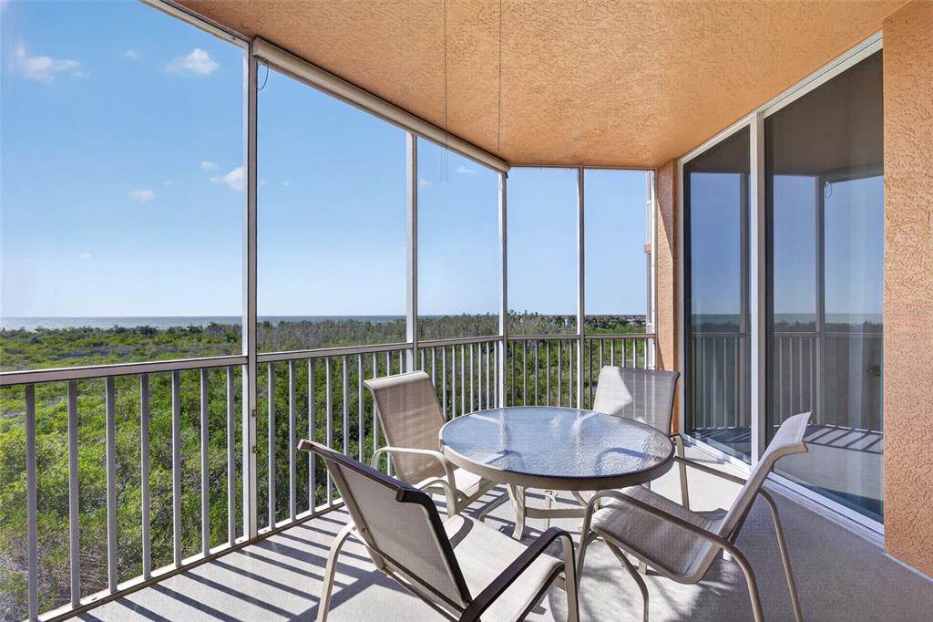 3191 Matecumbe Key Road, Unit 304 Punta Gorda, FL 33955 - Photo 19 of 31 a view of a balcony with a table and chairs
