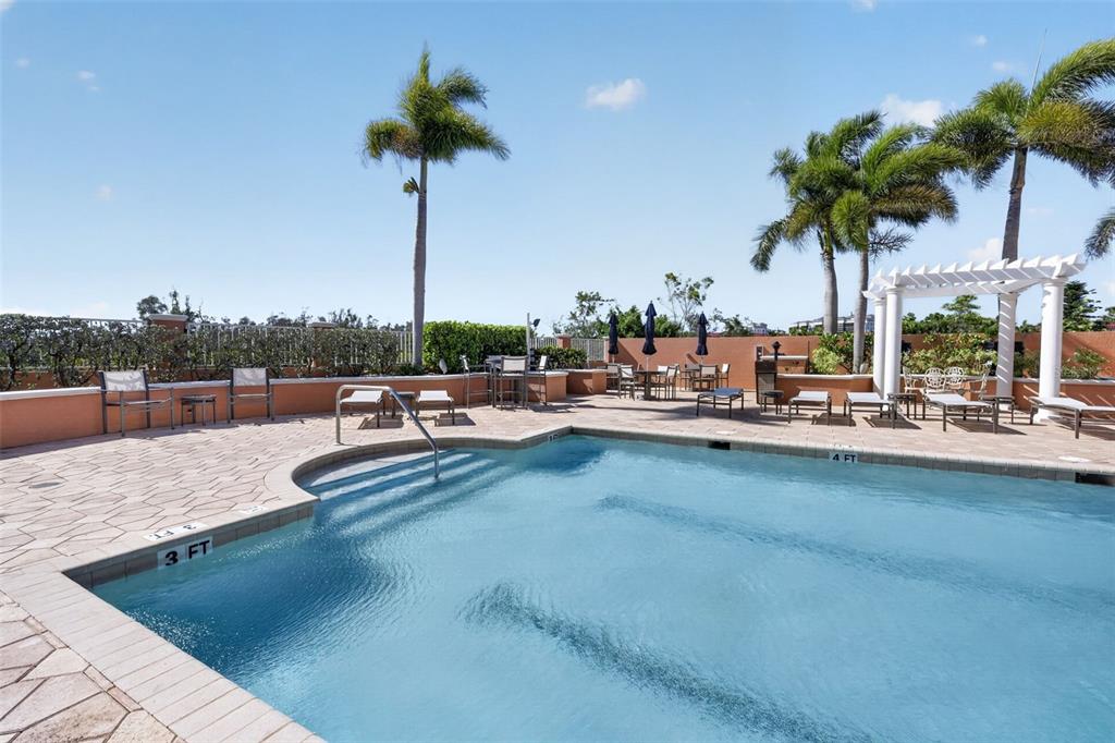 3191 Matecumbe Key Road, Unit 304 Punta Gorda, FL 33955 - Photo 31 of 31 a view of a swimming pool with a table and chairs