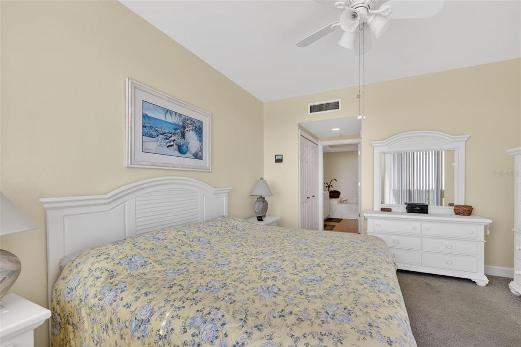 3191 Matecumbe Key Road, Unit 304 Punta Gorda, FL 33955 - Photo 4 of 31 a bedroom with a large bed and a chandelier