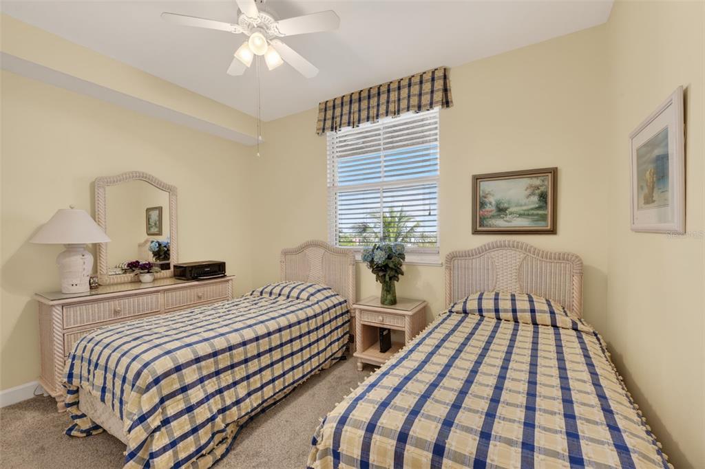 3191 Matecumbe Key Road, Unit 304 Punta Gorda, FL 33955 - Photo 8 of 31 a bedroom with a bed and a chandelier