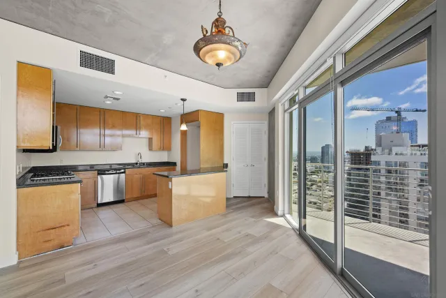 a kitchen with stainless steel appliances granite countertop a stove a sink and a microwave