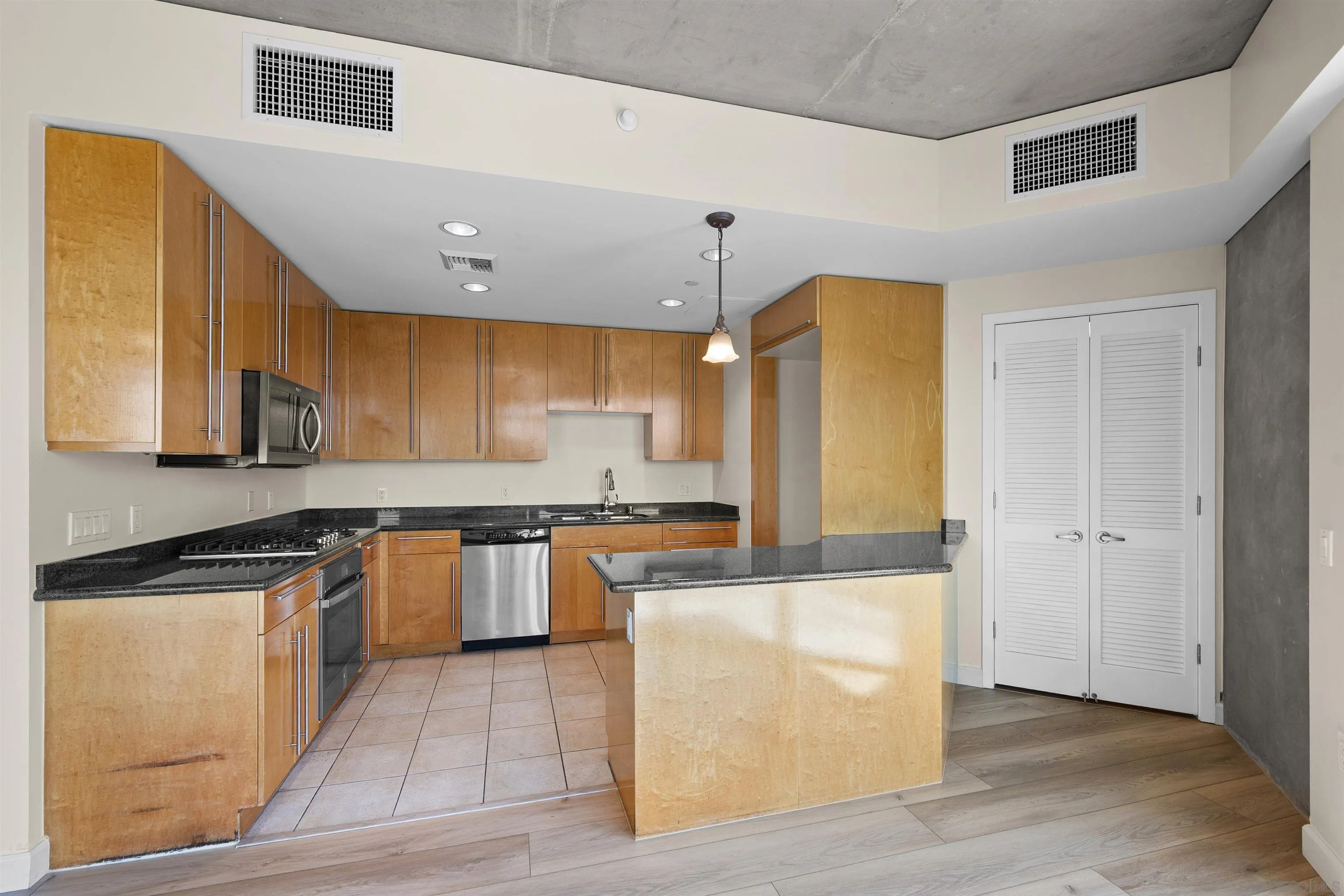 801 Ash Street, Unit 1701 San Diego, CA 92101 - Photo 26 of 44 a kitchen with stainless steel appliances granite countertop a stove a sink and a refrigerator