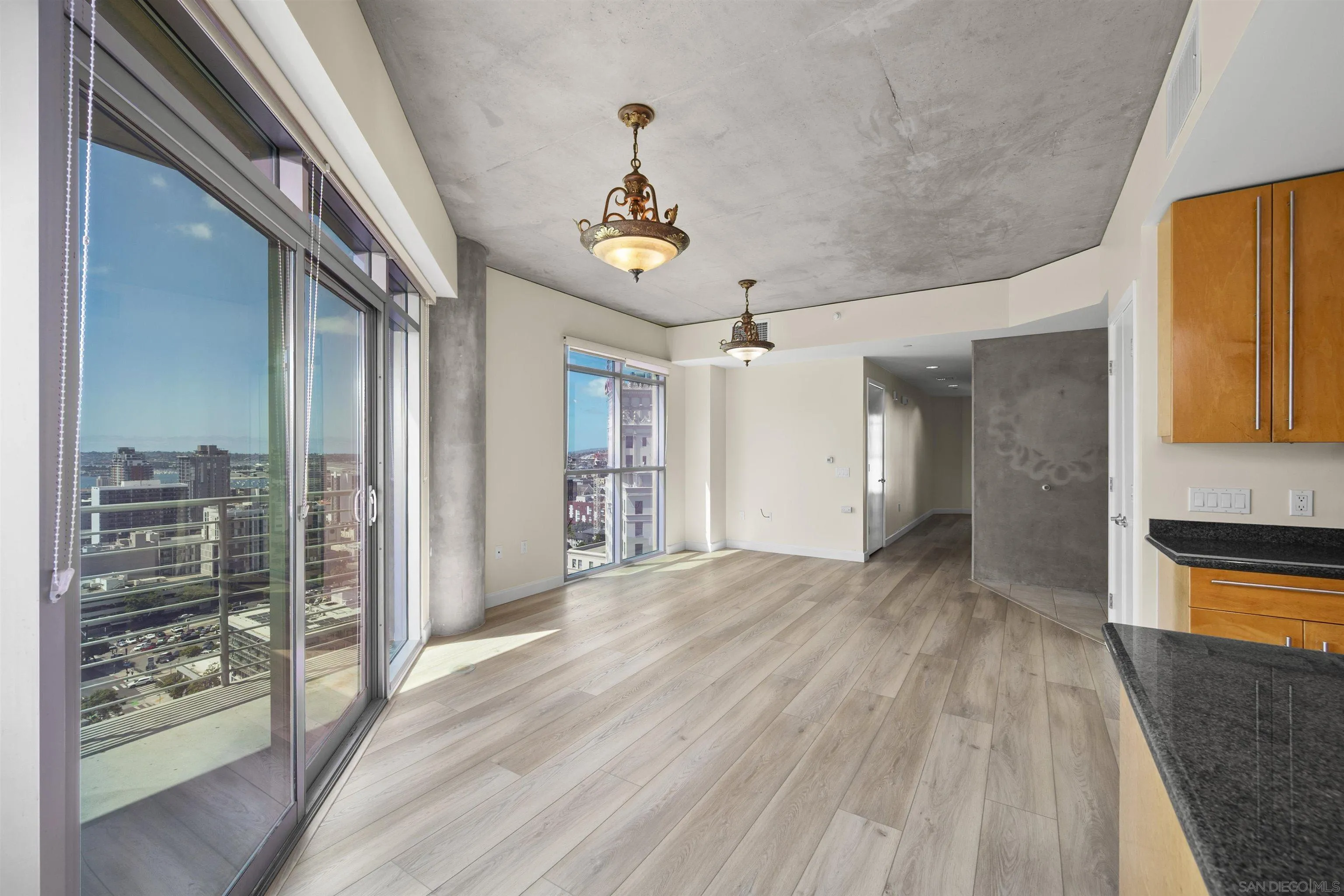 801 Ash Street, Unit 1701 San Diego, CA 92101 - Photo 28 of 44 a view of a hallway with wooden floor and a kitchen