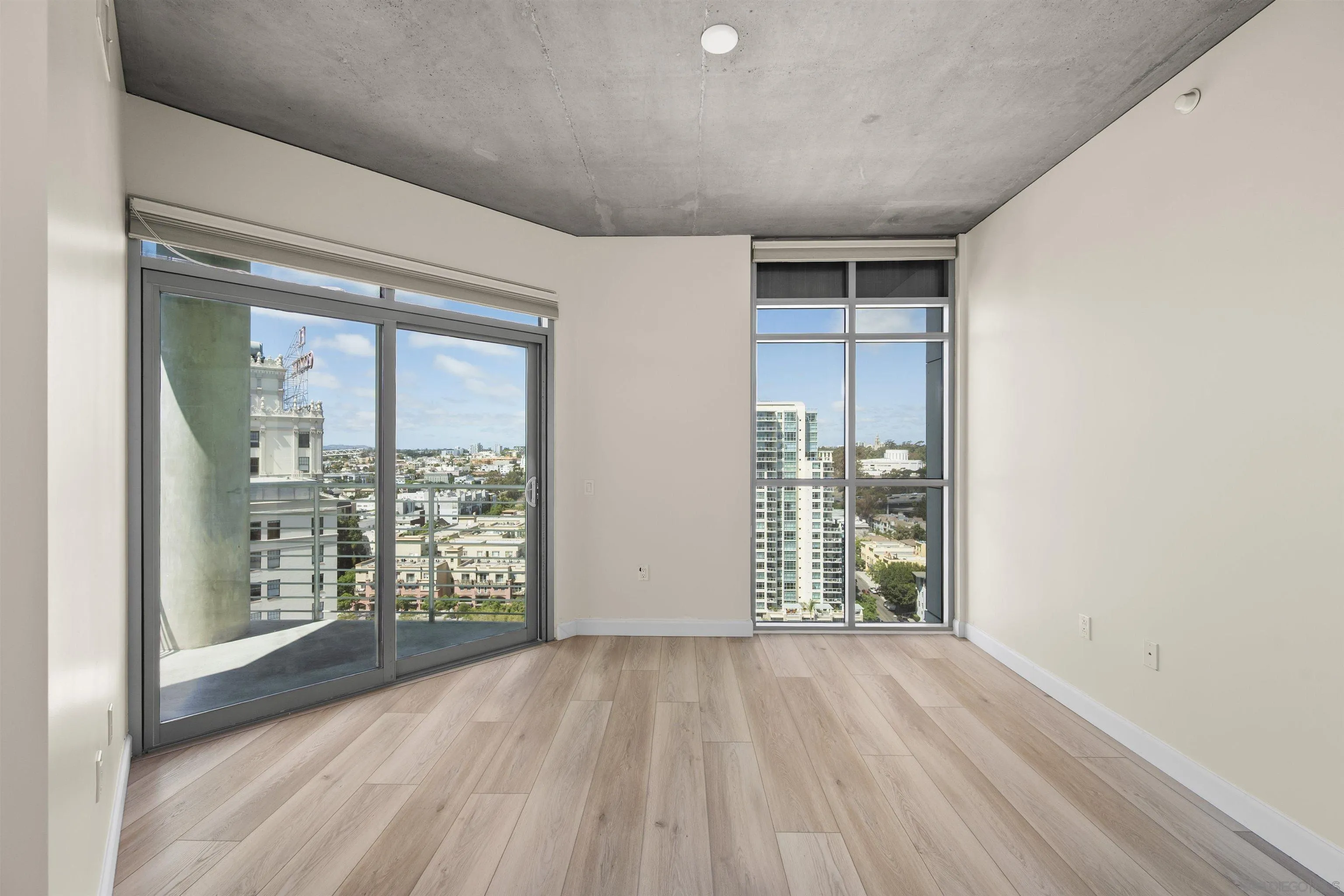 801 Ash Street, Unit 1701 San Diego, CA 92101 - Photo 30 of 44 an empty room with wooden floor and windows