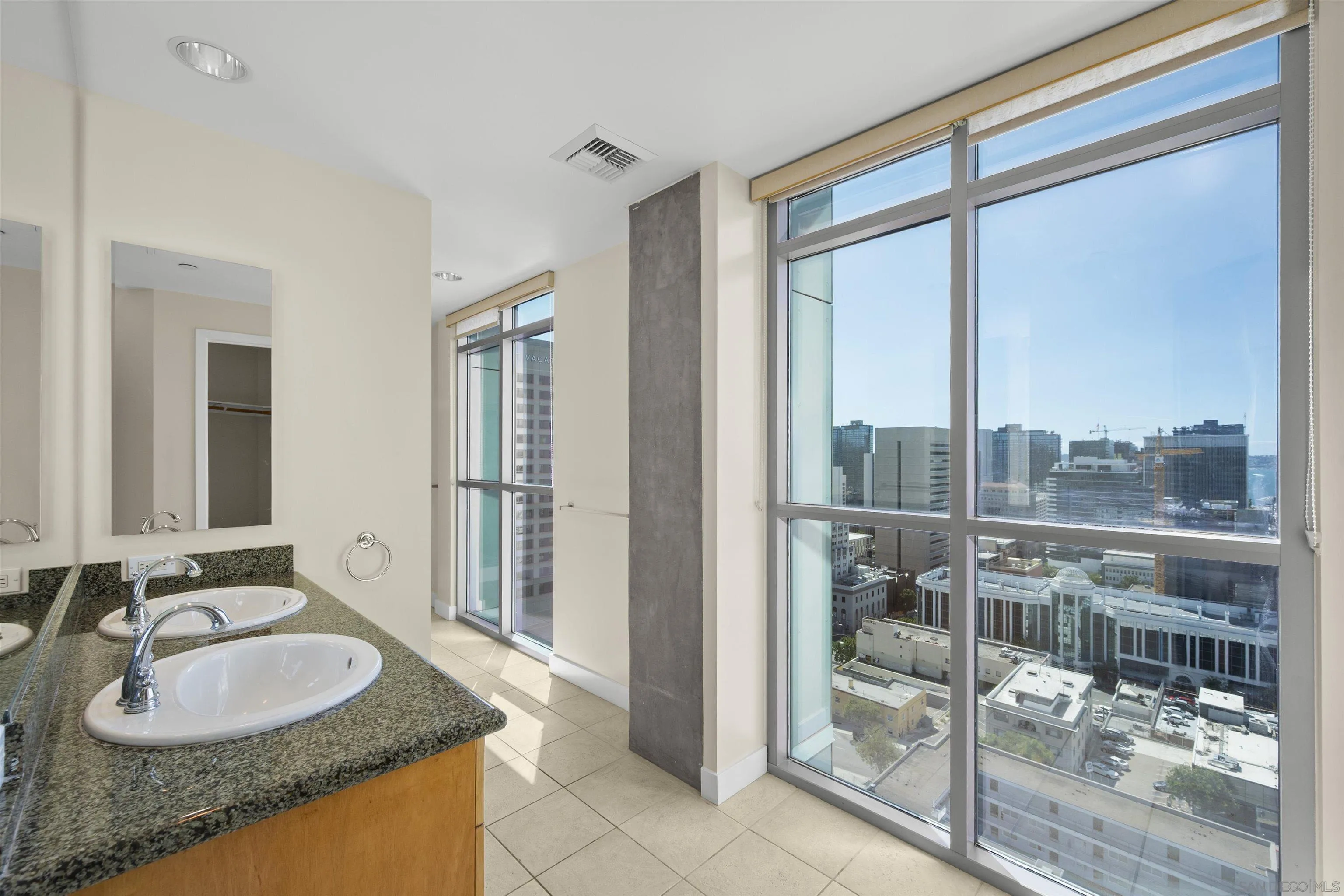 801 Ash Street, Unit 1701 San Diego, CA 92101 - Photo 38 of 44 a bathroom with a granite countertop sink and a mirror
