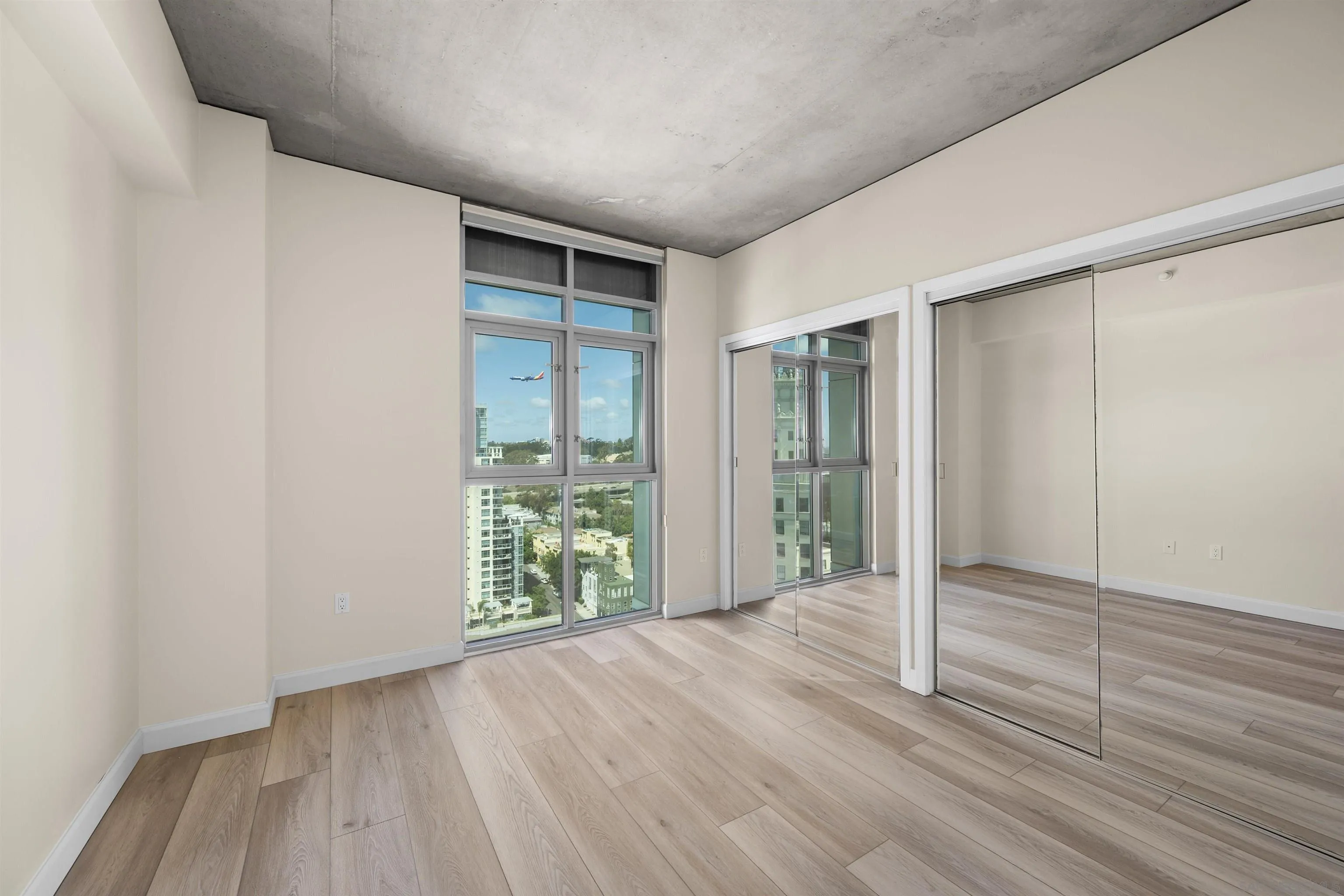 801 Ash Street, Unit 1701 San Diego, CA 92101 - Photo 43 of 44 an empty room with wooden floor and windows