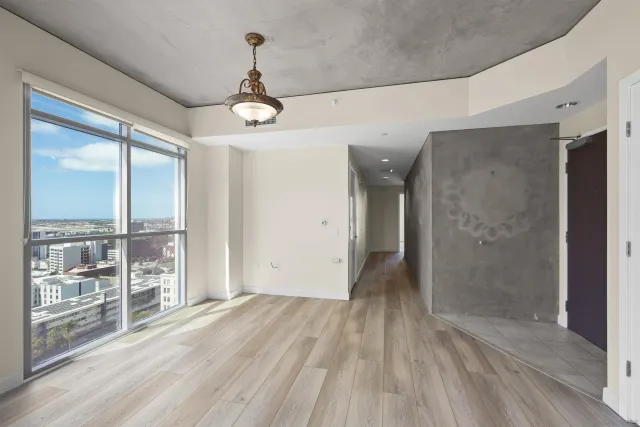 a view of a livingroom with wooden floor and a ceiling fan