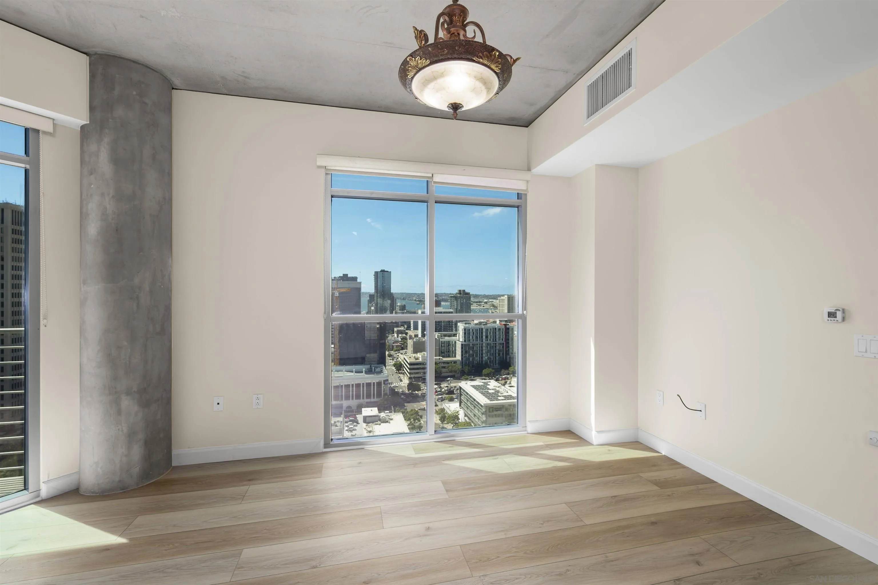 801 Ash Street, Unit 1701 San Diego, CA 92101 - Photo 9 of 44 a view of a livingroom with wooden floor and a ceiling fan