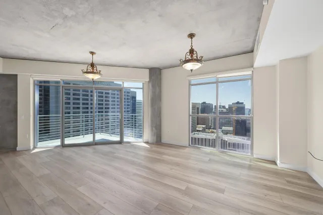 a view of a kitchen with wooden floor and windows