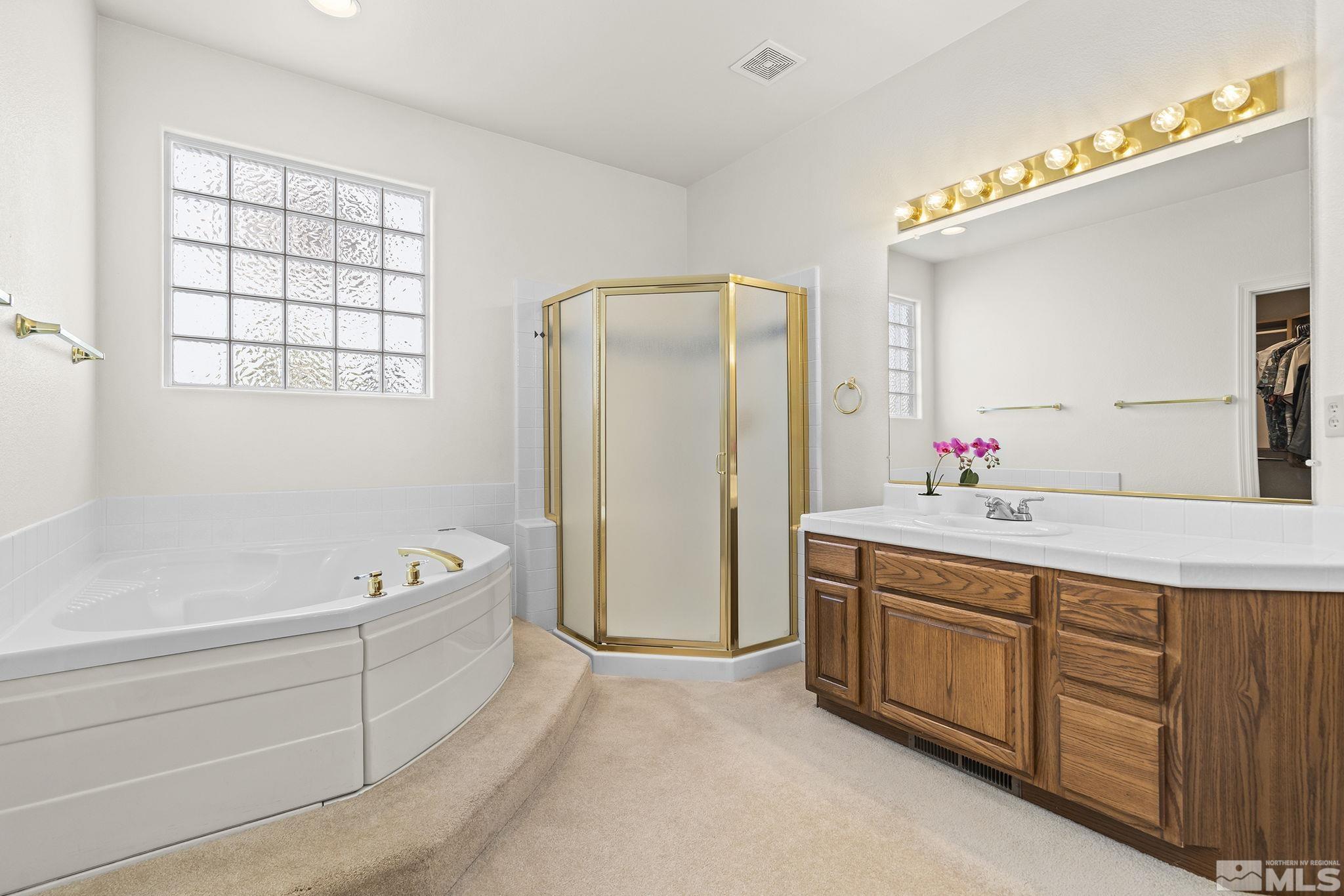 3310 Snake River Drive Reno, NV 89503 - Photo 11 of 33 a spacious bathroom with a tub sink and mirror