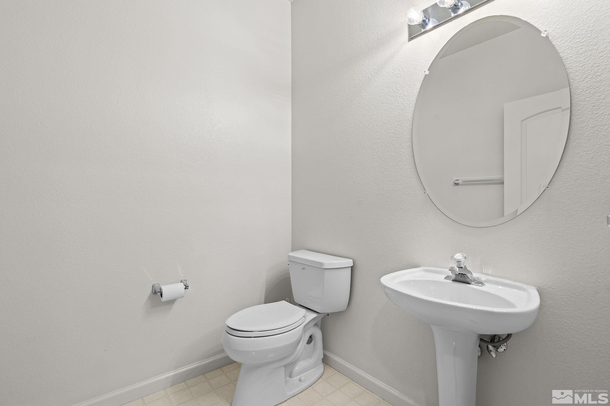 3310 Snake River Drive Reno, NV 89503 - Photo 13 of 33 a bathroom with a sink a toilet and a mirror