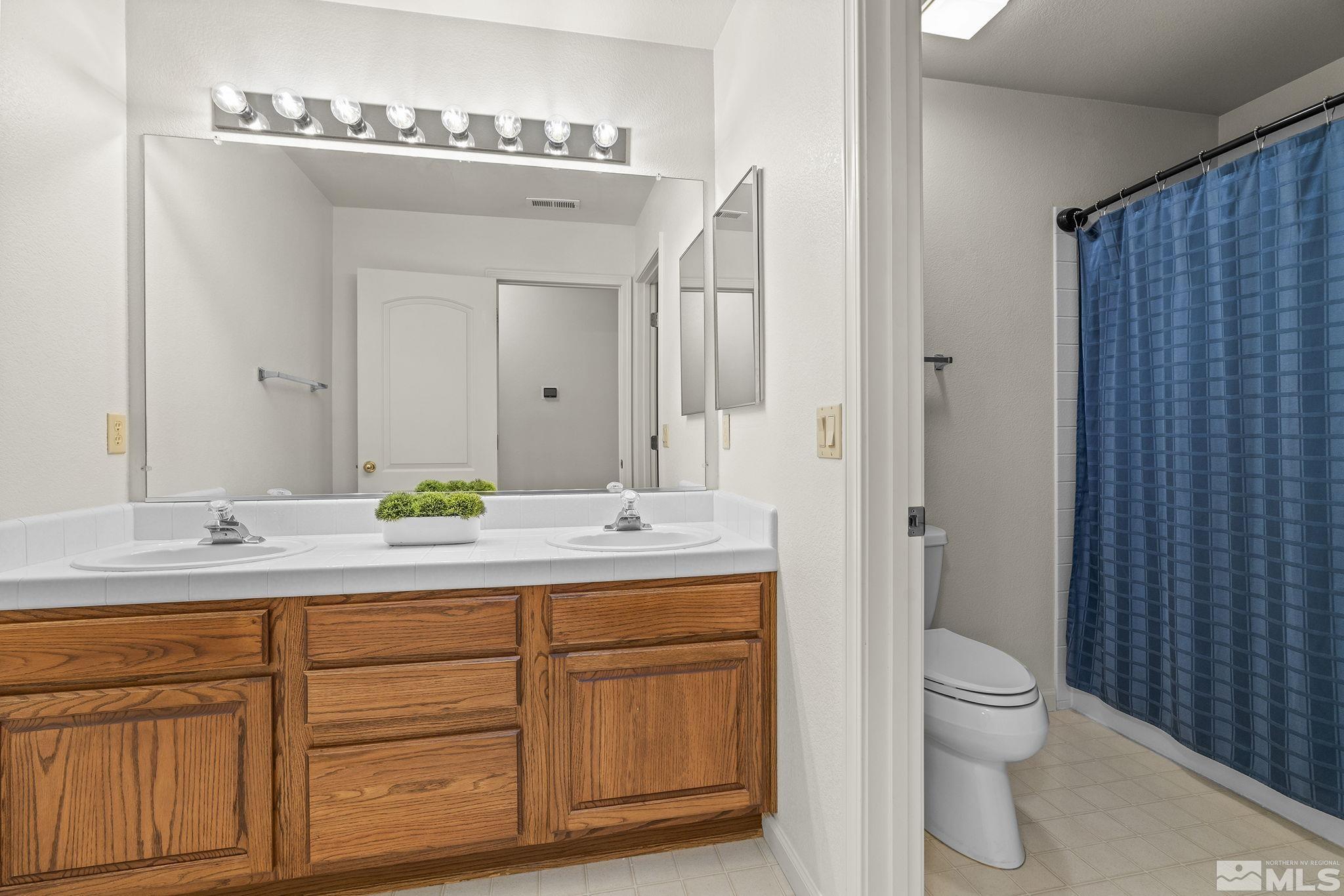 3310 Snake River Drive Reno, NV 89503 - Photo 24 of 33 a spacious bathroom with a granite countertop sink and a mirror