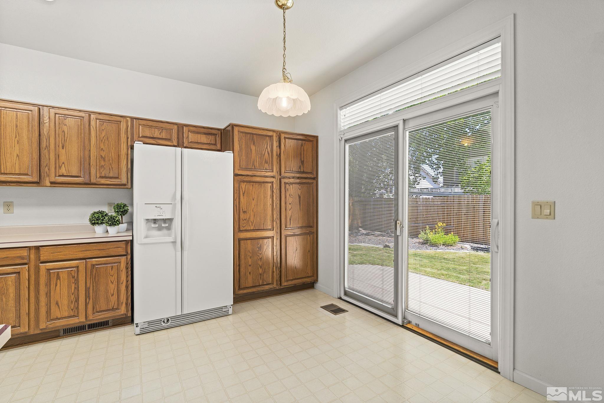 3310 Snake River Drive Reno, NV 89503 - Photo 4 of 33 a kitchen with refrigerator and window