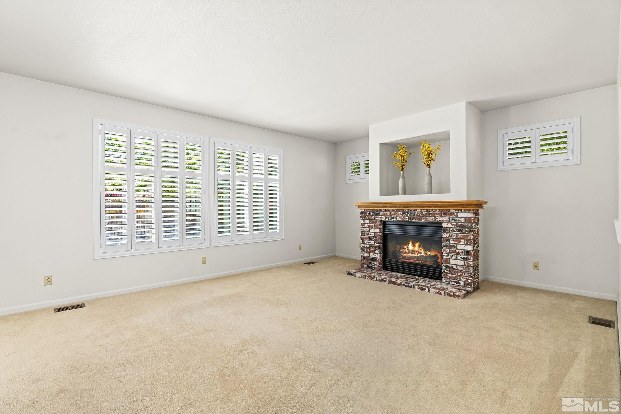 3310 Snake River Drive Reno, NV 89503 - Photo 5 of 33 an empty room with furniture and a fireplace