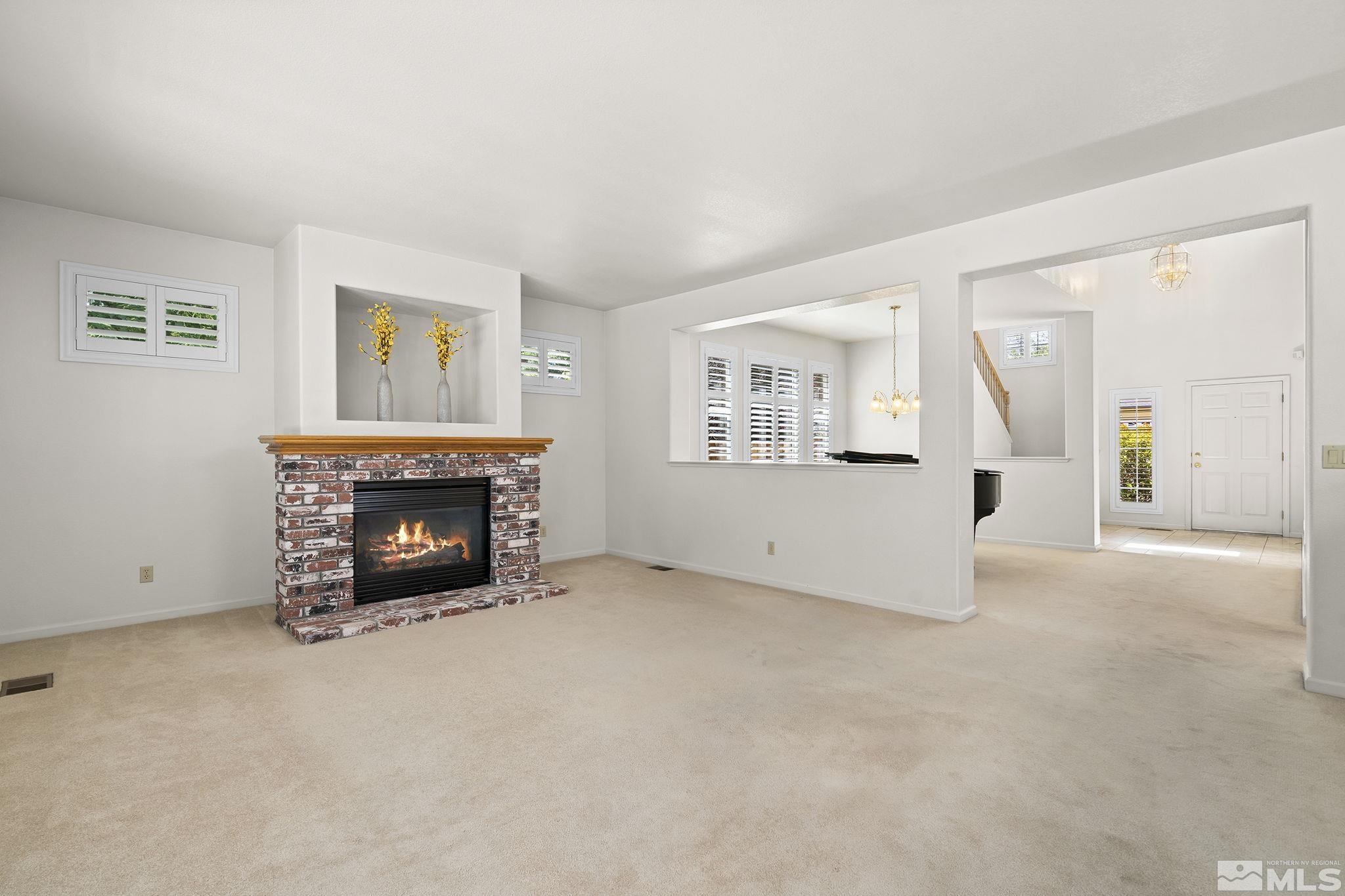 3310 Snake River Drive Reno, NV 89503 - Photo 6 of 33 an empty room with furniture and a fireplace