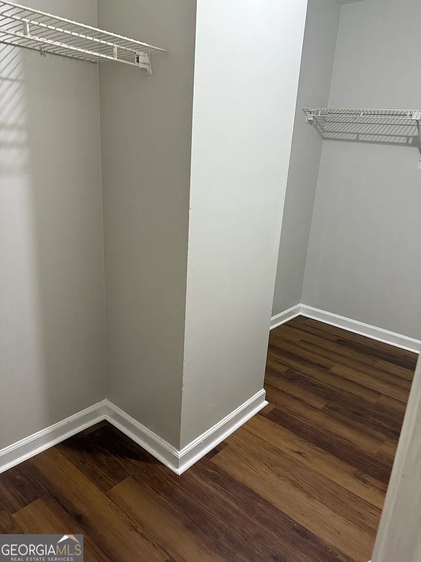 4534 Golf Vista Circle Decatur, GA 30035 - Photo 13 of 17 Large walk-in closet with double hanging racks and ample shelving - a renter's dream for organized storage.