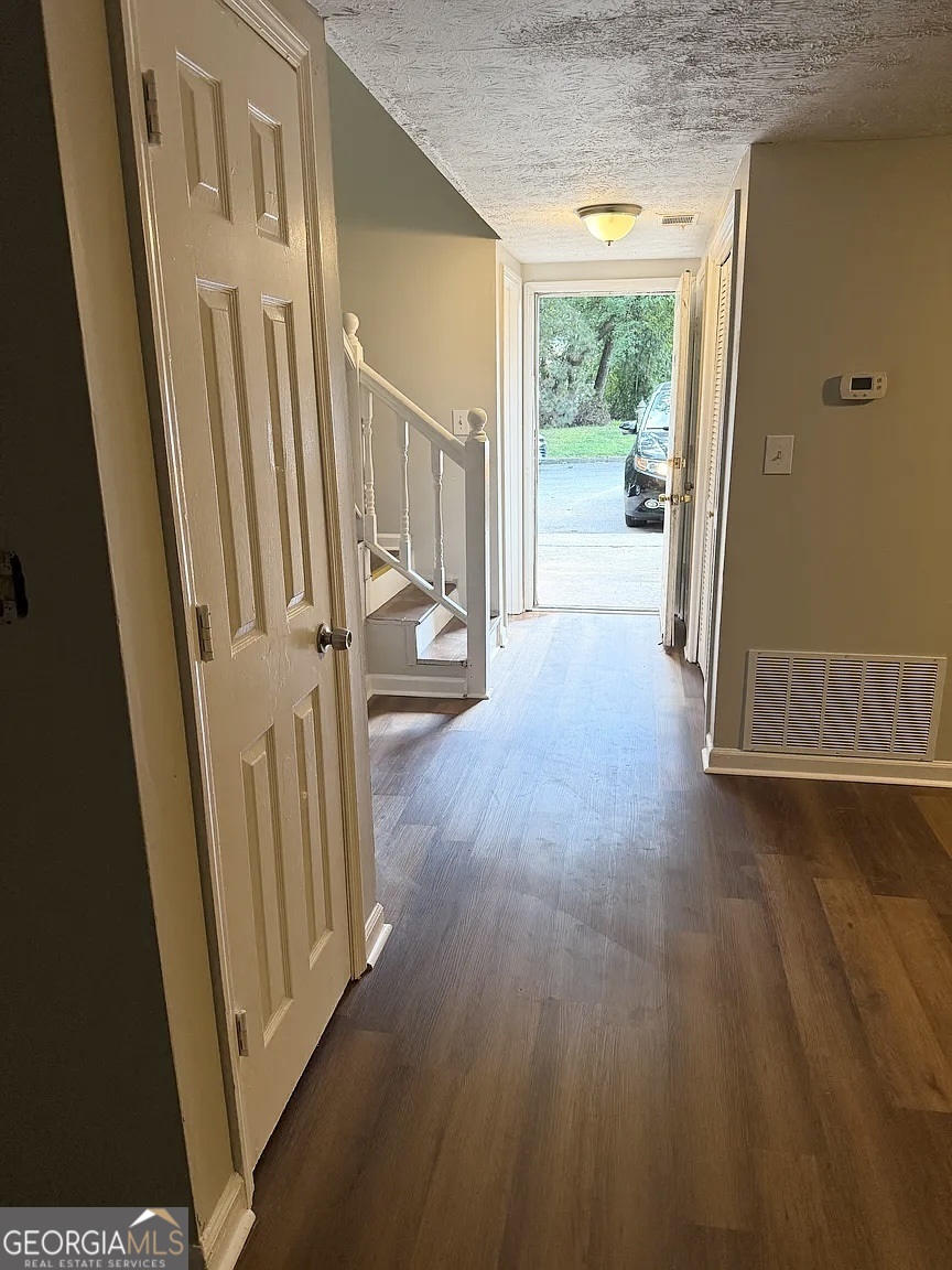 4534 Golf Vista Circle Decatur, GA 30035 - Photo 2 of 17 View from the front door with attractive wood-look flooring throughout and open flow toward the main living area.