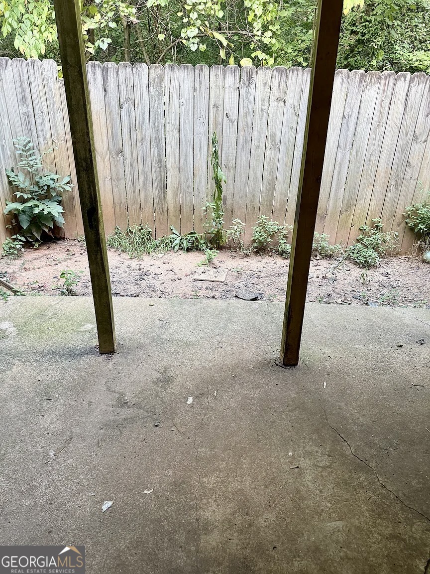 4534 Golf Vista Circle Decatur, GA 30035 - Photo 5 of 17 Private fenced-in patio area with wooded backdrop for added privacy and easy access from the living room.