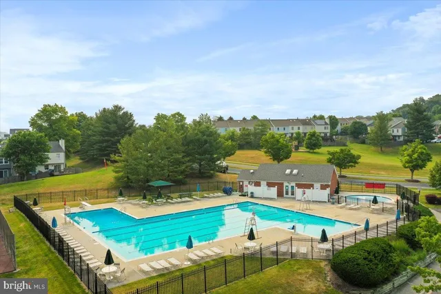 an aerial view of a house with swimming pool patio and outdoor seating