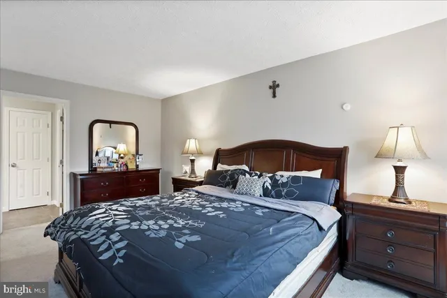 a bedroom with a bed and a television