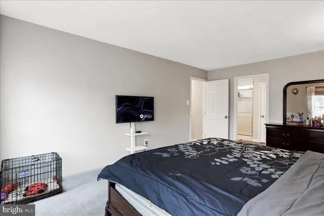 a view of walk in closet with clothes