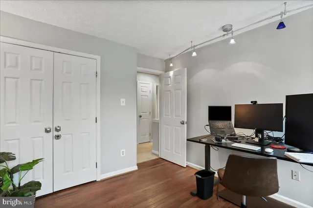 a view of empty room with wooden floor