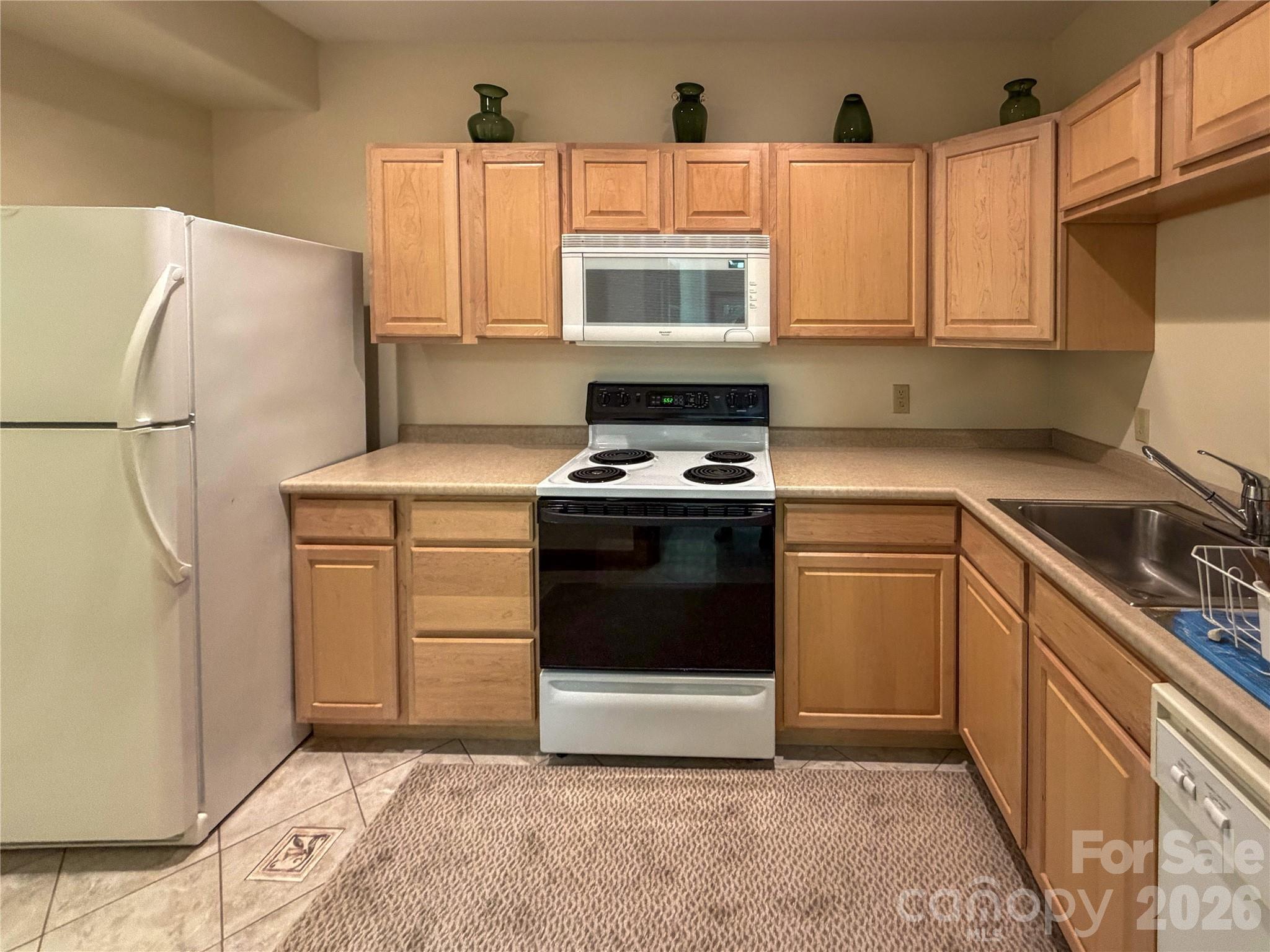 556 Quail Ridge Boulevard Lake Lure, NC 28746 - Photo 39 of 48 a kitchen with a stove a sink and a refrigerator