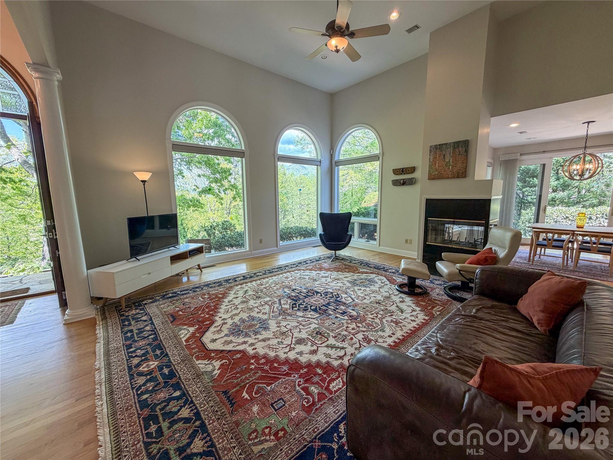 556 Quail Ridge Boulevard Lake Lure, NC 28746 - Photo 10 of 48 a living room with furniture fireplace and flat screen tv