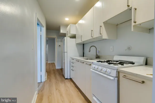a kitchen with a stove and a refrigerator