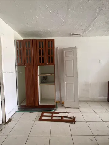 a room with a washing machine and cabinets