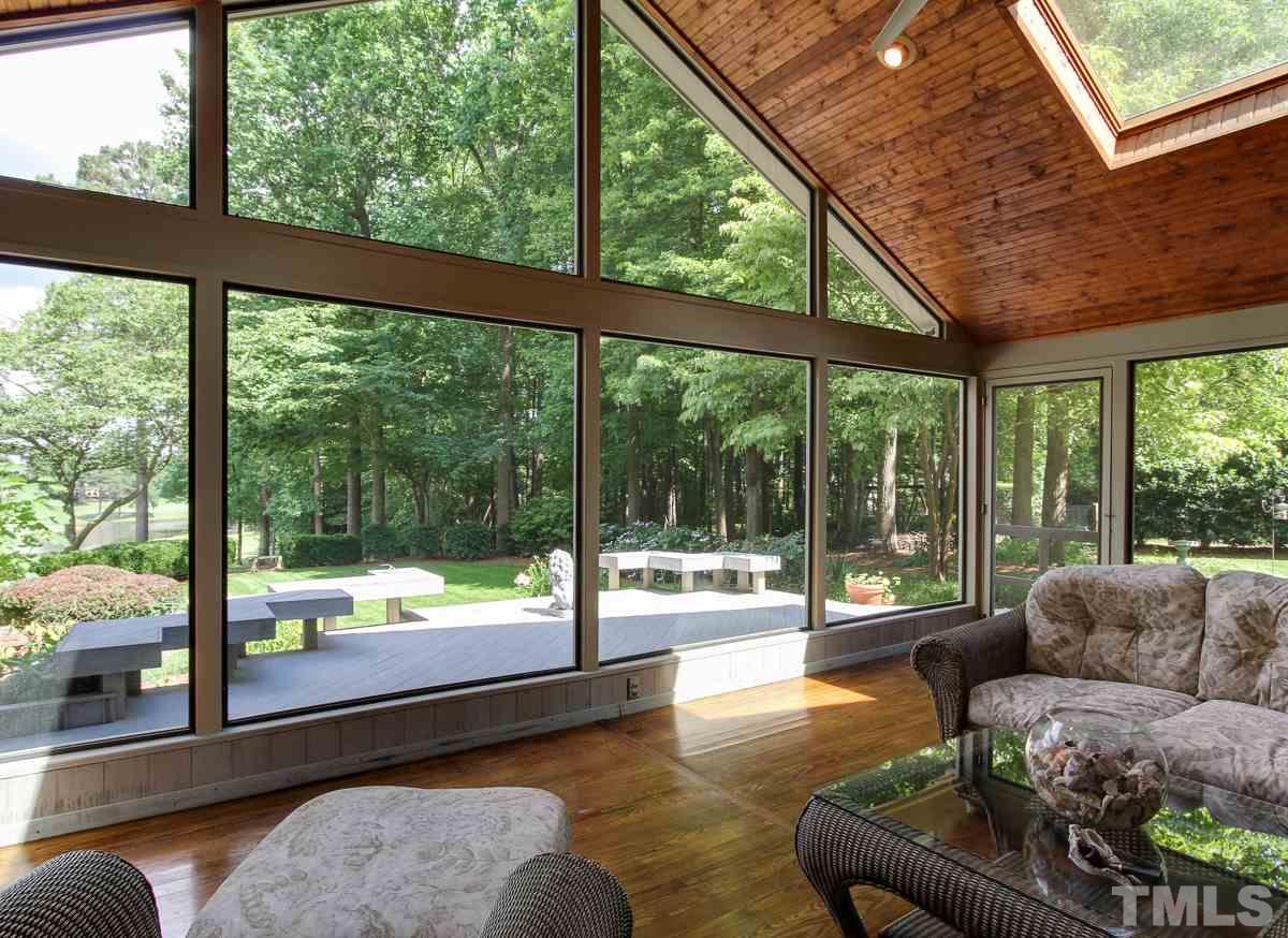 7108 Rainwater Road Raleigh, NC 27615 - Photo 22 of 25 a living room with couch and a floor to ceiling window