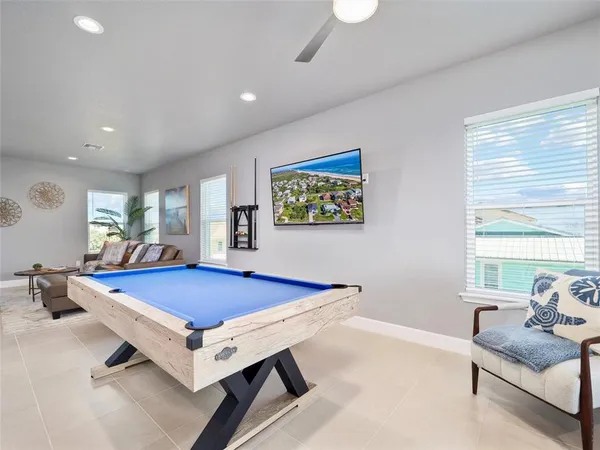 a living room with furniture gym equipment and a large window