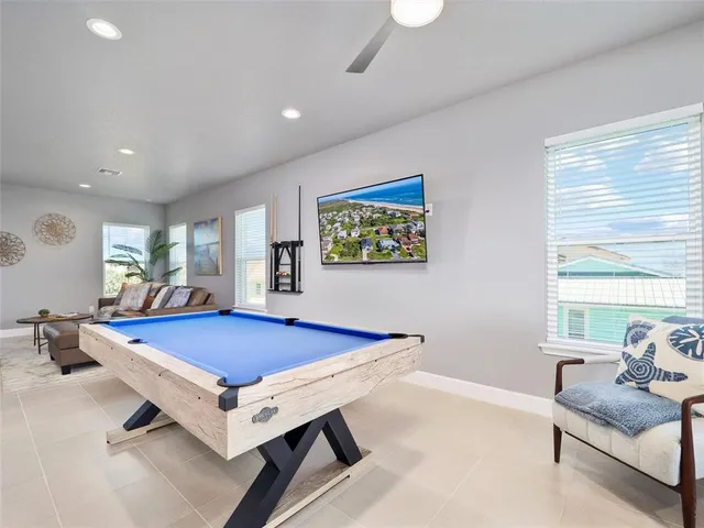 a living room with furniture gym equipment and a large window