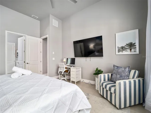 a bedroom with a bed and a flat screen tv